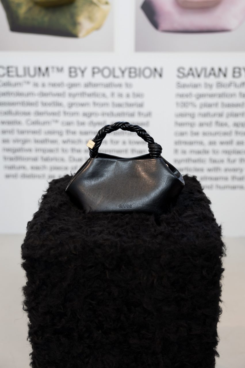 Black Ganni bou bag on a furry pedestal