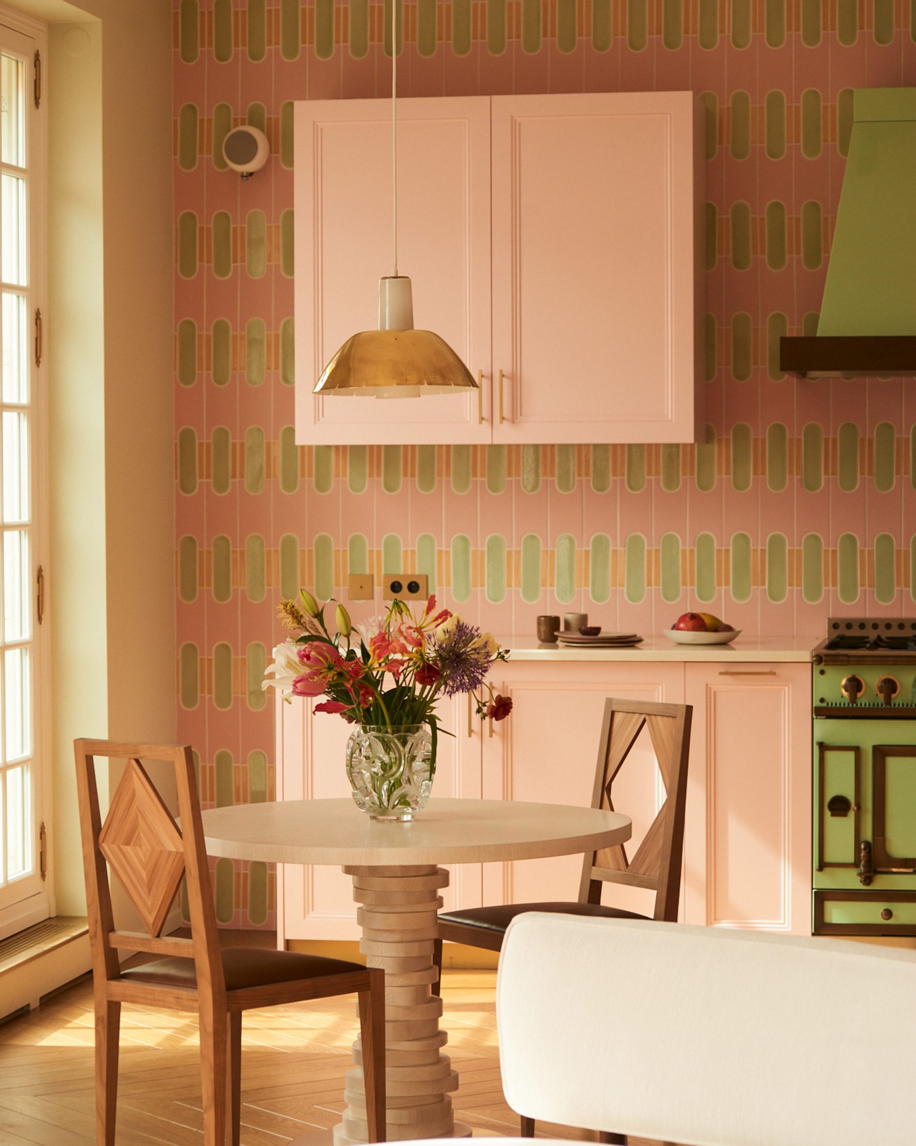 Pink and green kitchen within Paris apartment