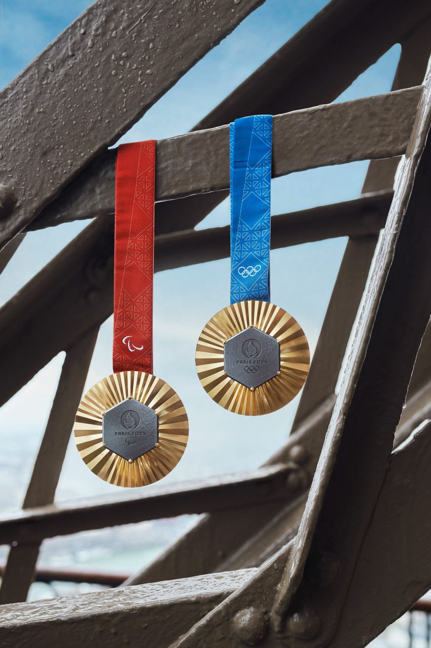 Two gold medals hanging from the Eiffel tower