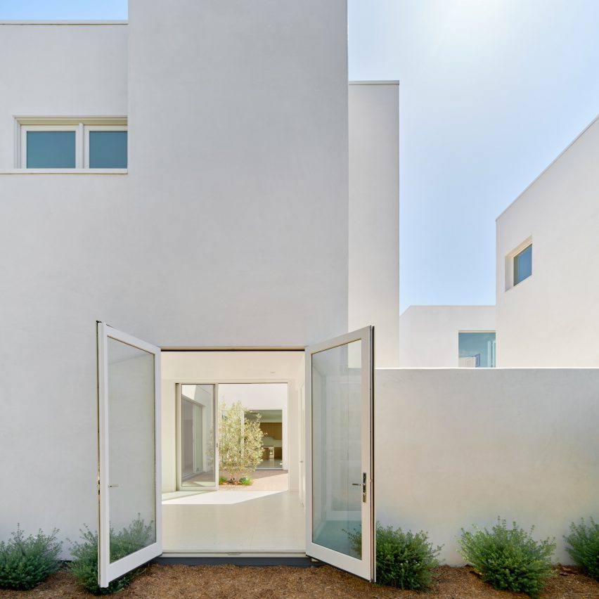White stucco home with open door