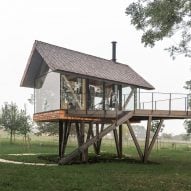 Exterior of glass micro house on stilts by Jan Tyrpekl in Austria