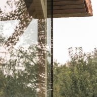 Close up of exterior glazing of micro house on stilts by Jan Tyrpekl in Austria