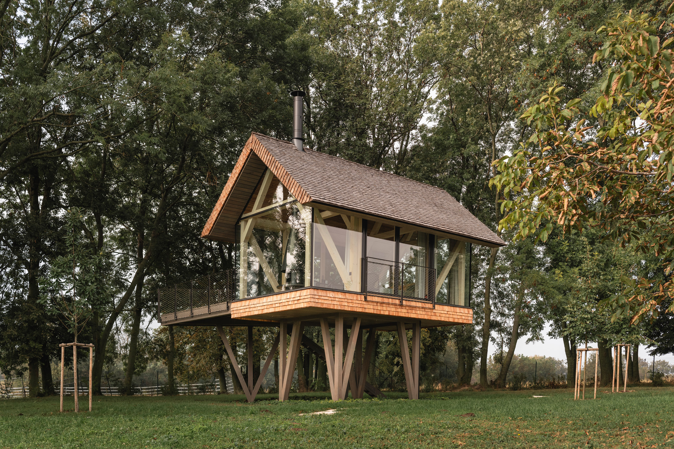 Exterior of glass micro house on stilts by Jan Tyrpekl in Austria