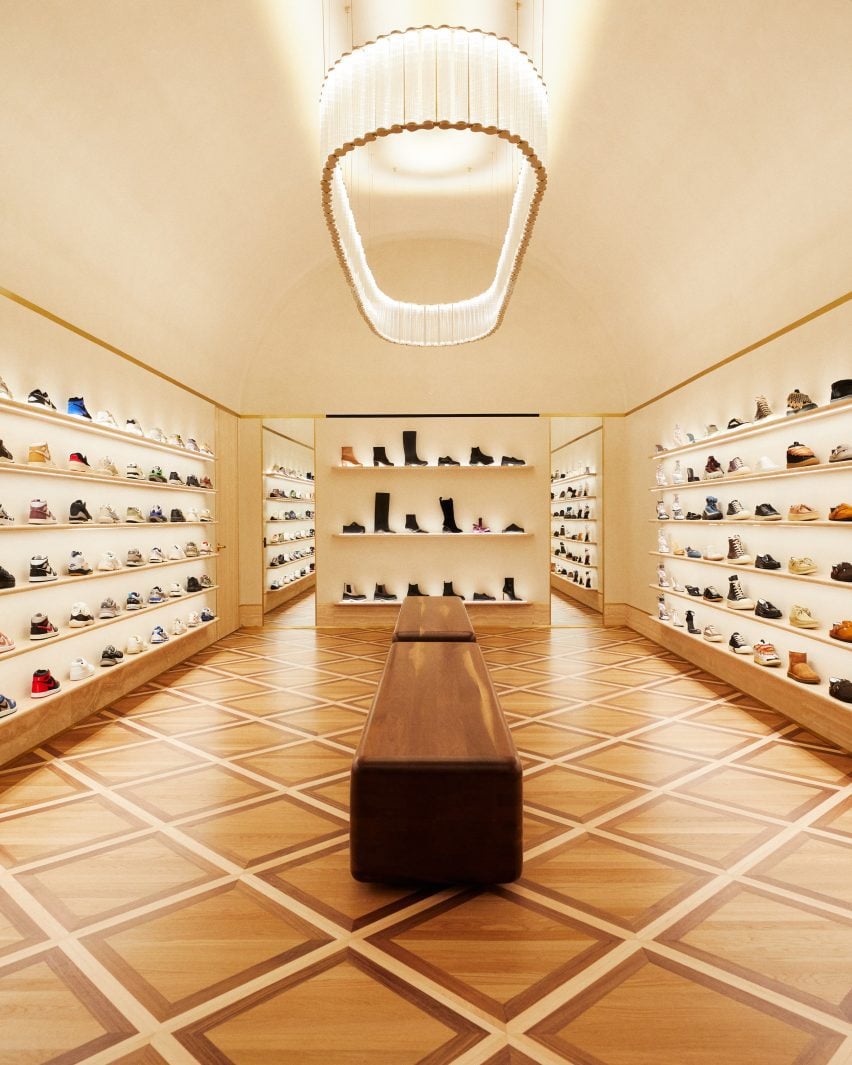 Footwear room with shoes presented on travertine shelves