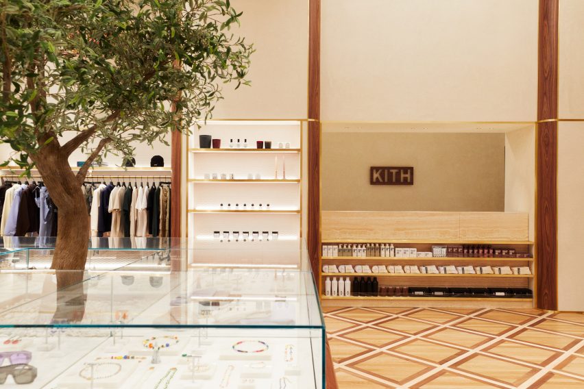 Kith Women store with apparel and accessories displayed in walnut and brass-trimmed niches