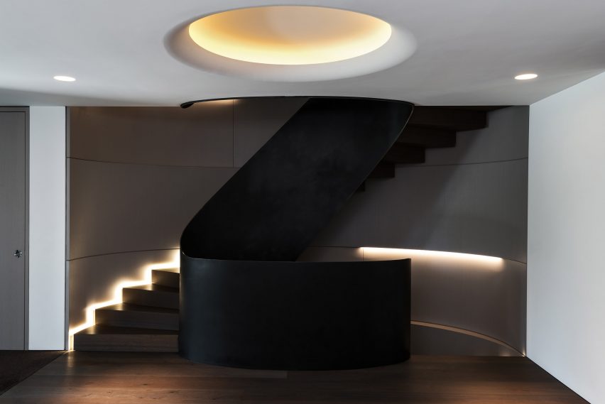 Spiral staircase inside cantilevered house by Küchel Architects in Switzerland