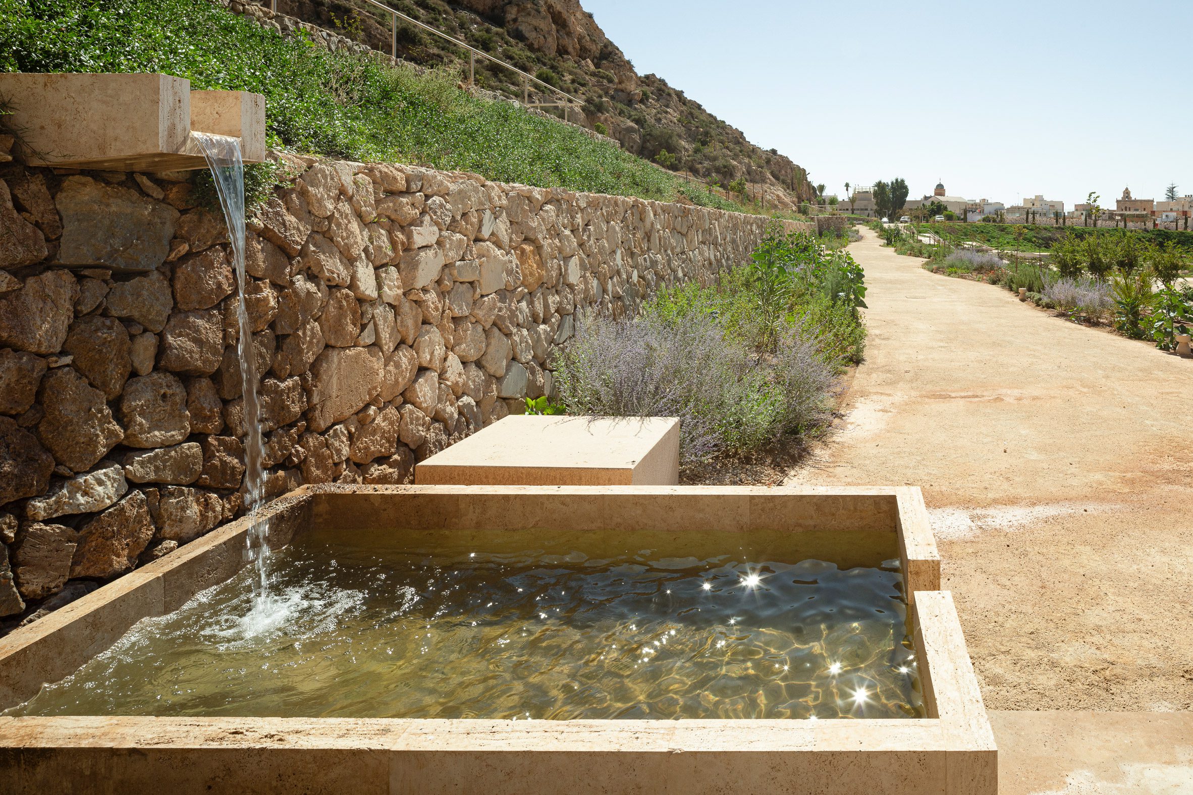 Restored water basin within park restoration by Kauh Arquitectura