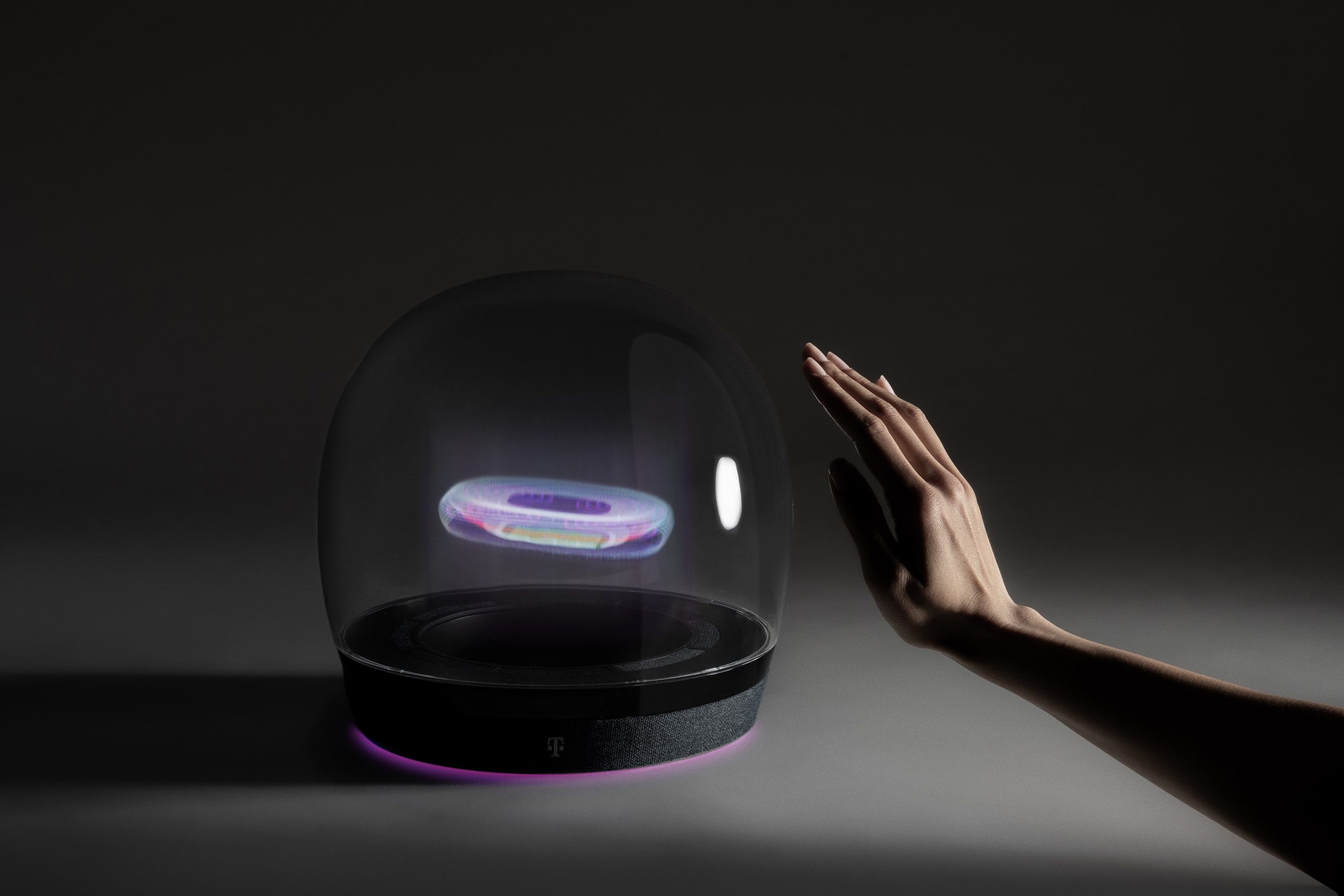 Photo of a prototype of Layer and Deutsche Telekom's Concept T holographic smarthome hub, showing a transparent domed unit containing a 3D holographic image