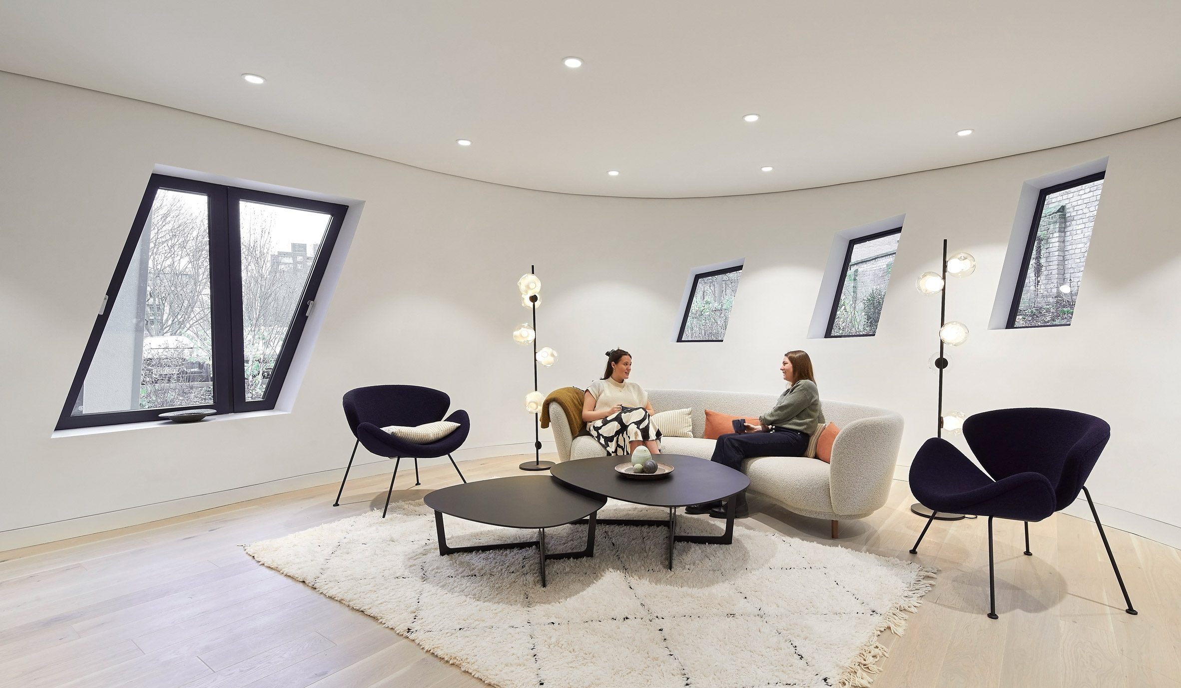 Lounge area with geometric windows by Studio Libeskind
