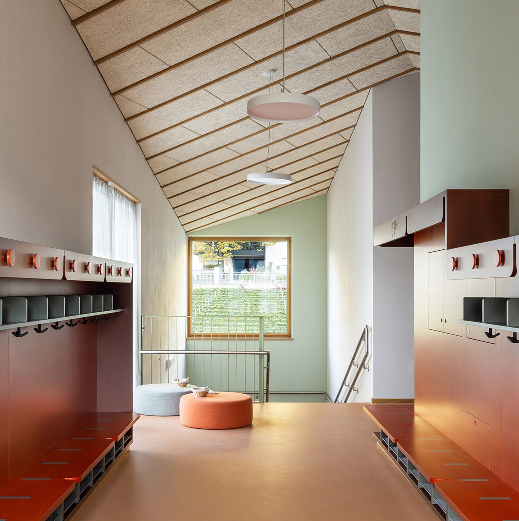 Interior of Tartan School featuring red-brick resin flooring, wooden ceilings and MDF furniture