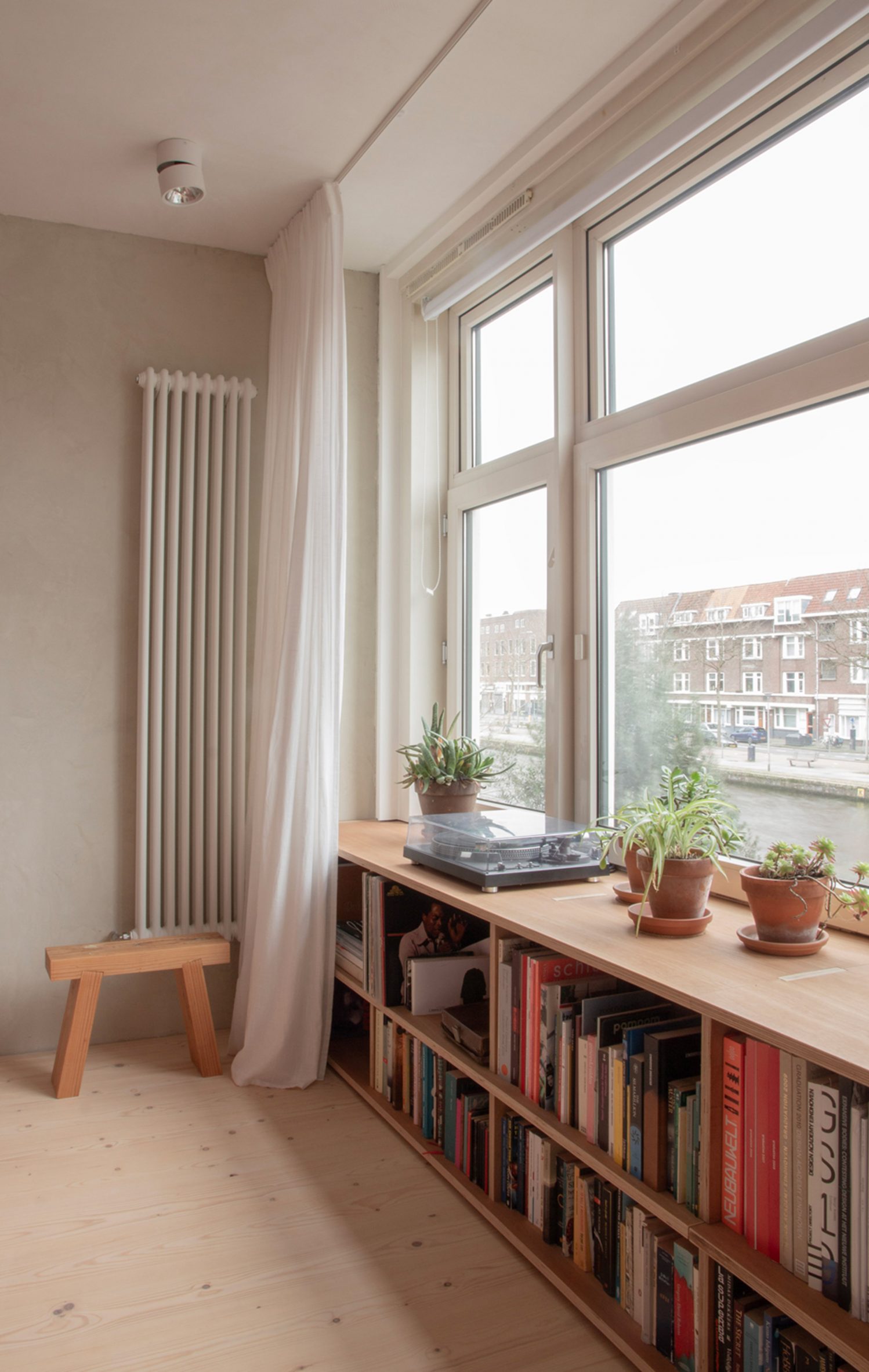 Bookshelf in Ulli Heckmann's compact apartment in Rotterdam