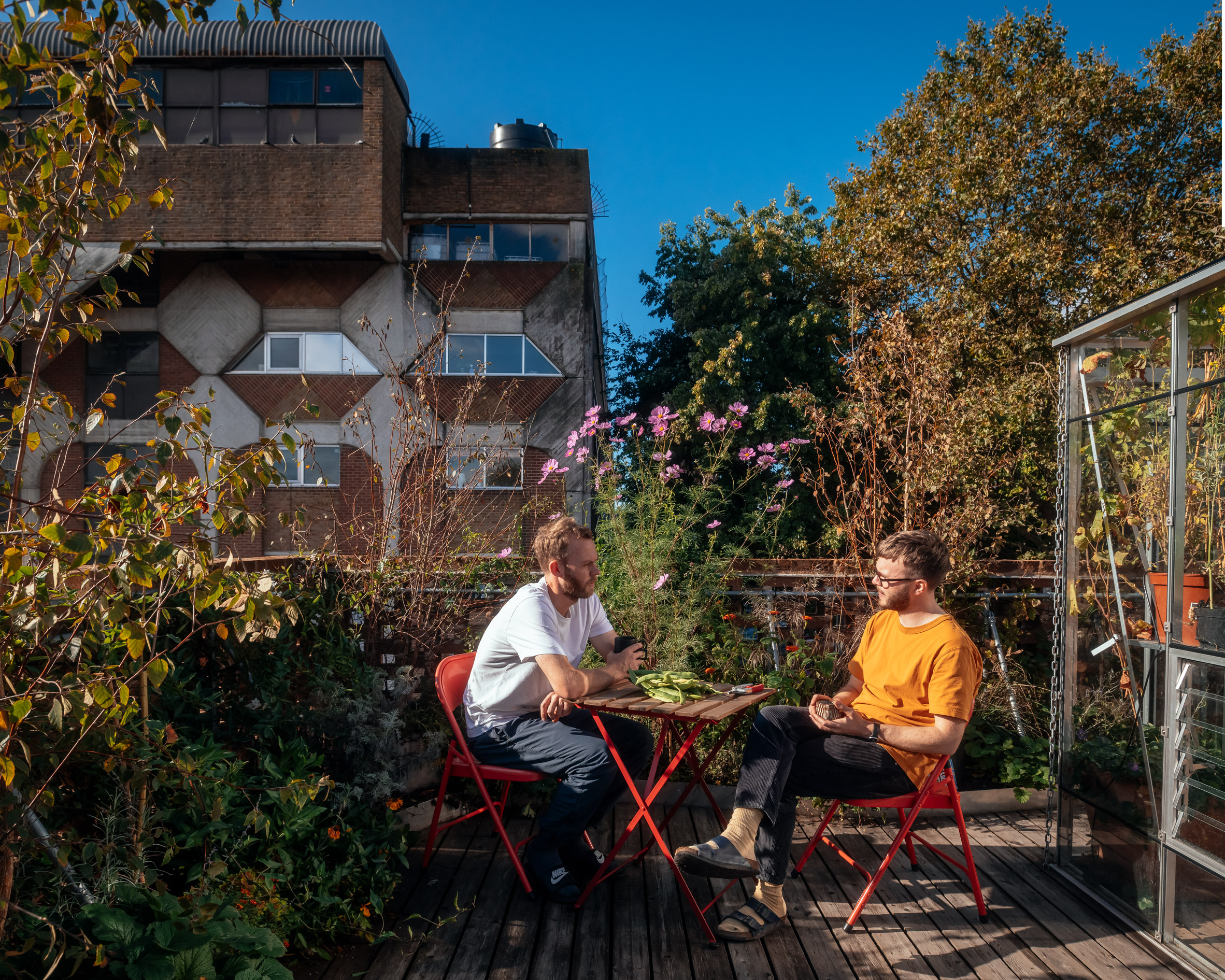 Surman Weston founders sitting on Peckham House rooftop