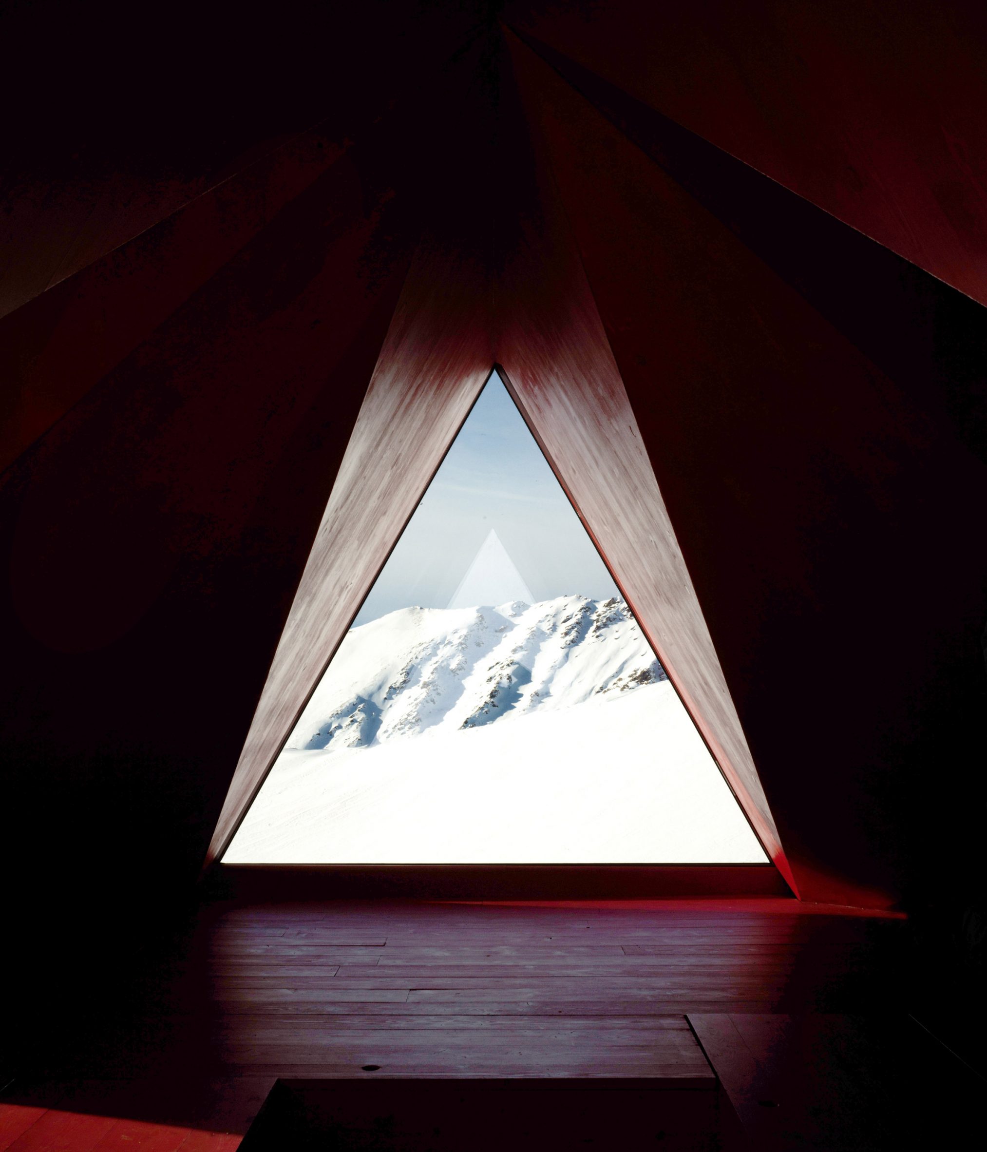 Triangle window of pinwheel shelter in the Italian Alps by EX