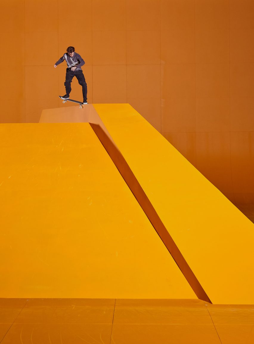 Man grinding on neon skate pyramid