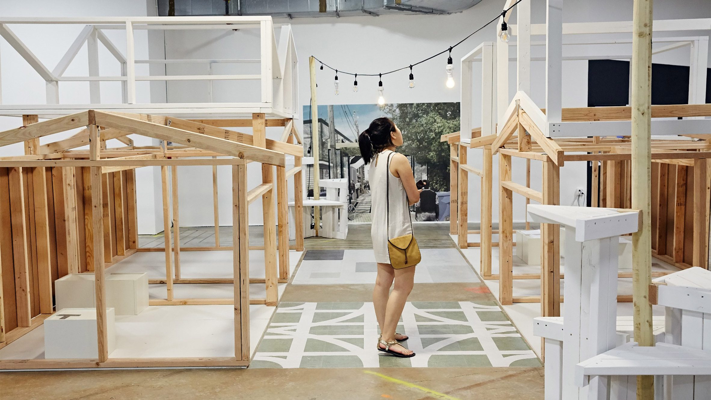 a photograph of a person standing within architectural models