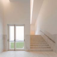 Stone staircase in a white gallery