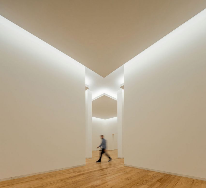 Gallery interior with white walls and wood flooring