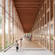Atelier WOA creates long timber-framed library in France
