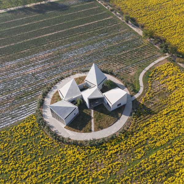 Paulo Merlini perches gabled volumes on top of stone plinth at Casa Rio