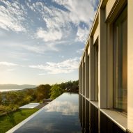 "Water mirror" reflects light into villa overlooking Lake Zurich by PPAA