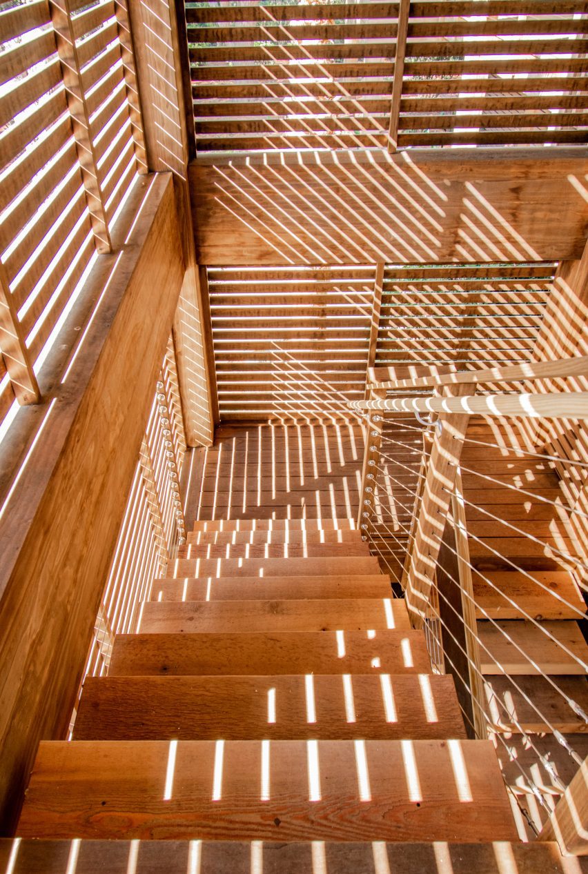 A sunlit wooden staircase