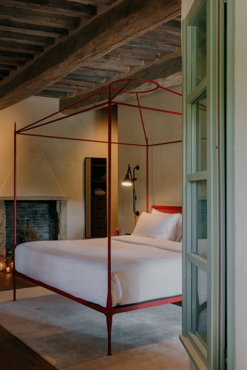 Bedroom with a red-framed, four-posted bed