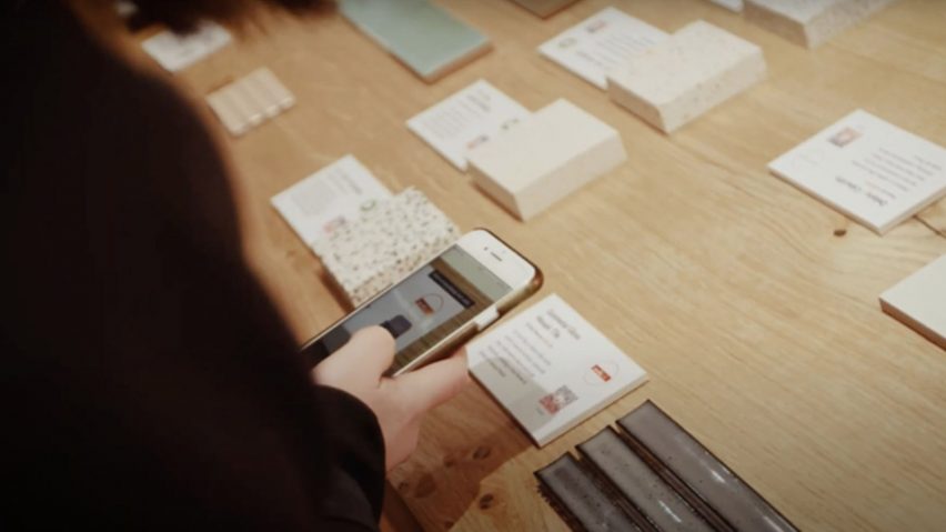Photo of person looking at material samples through their phone