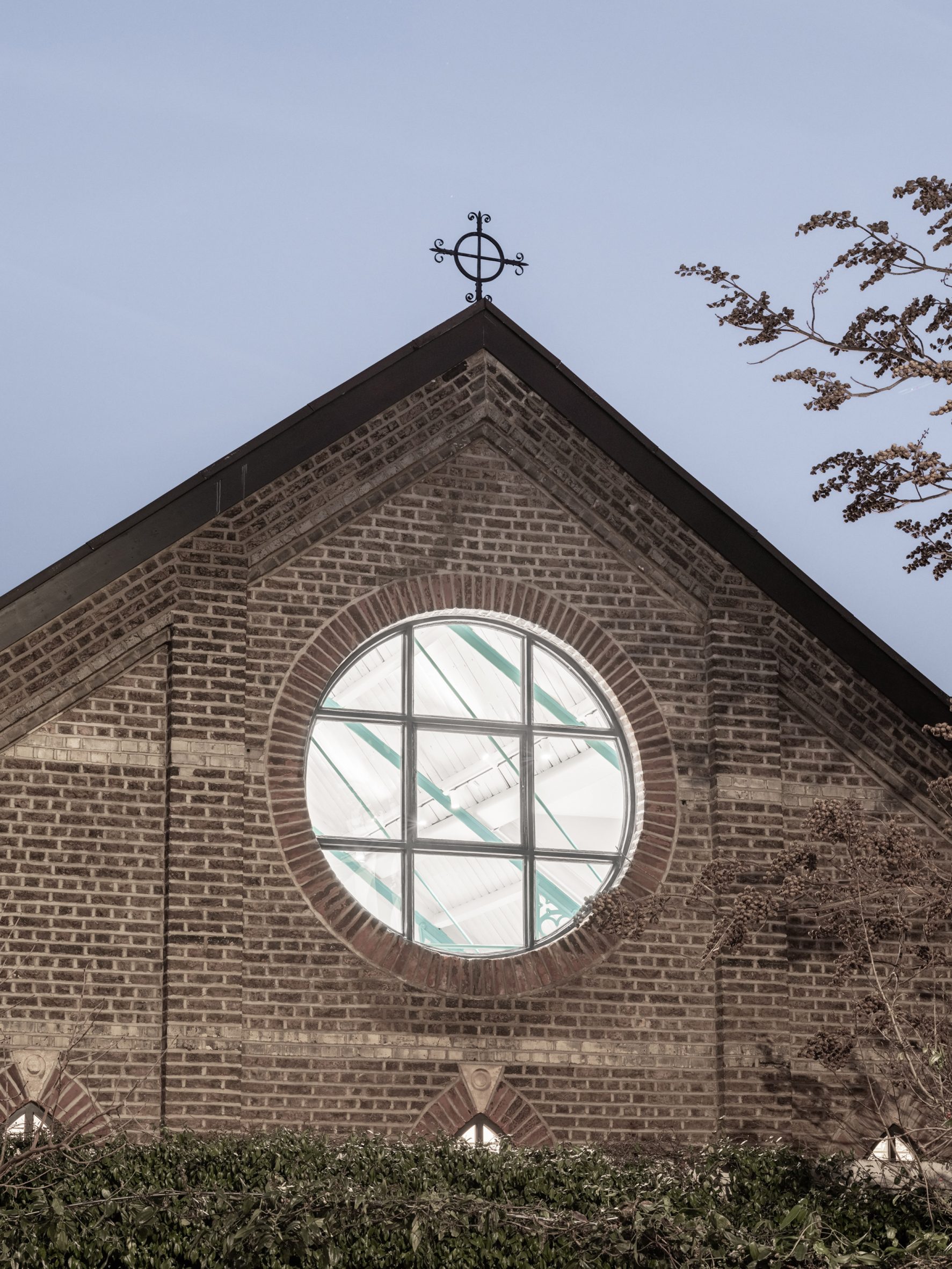 Gable end wall with rose window of Addison Studios by Tigg + Coll Architects