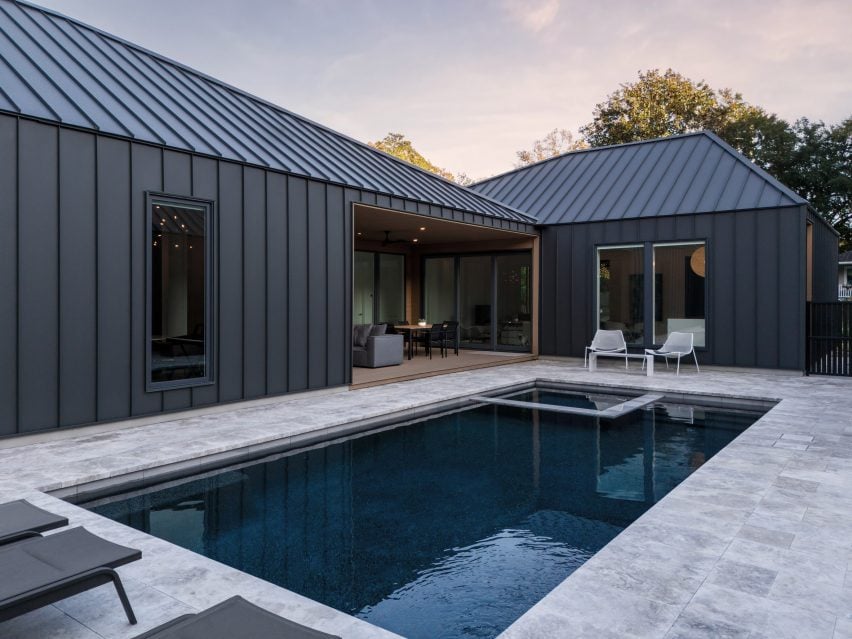 Black houses positioned around swimming pool