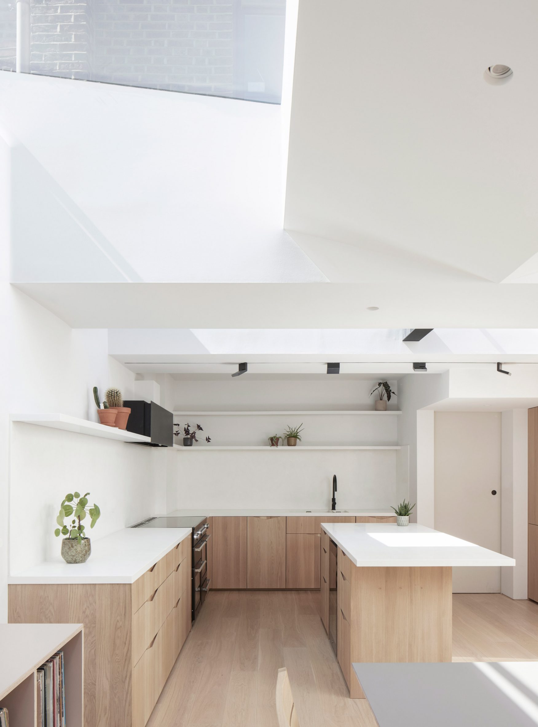 White kitchen with wooden cabinetry 