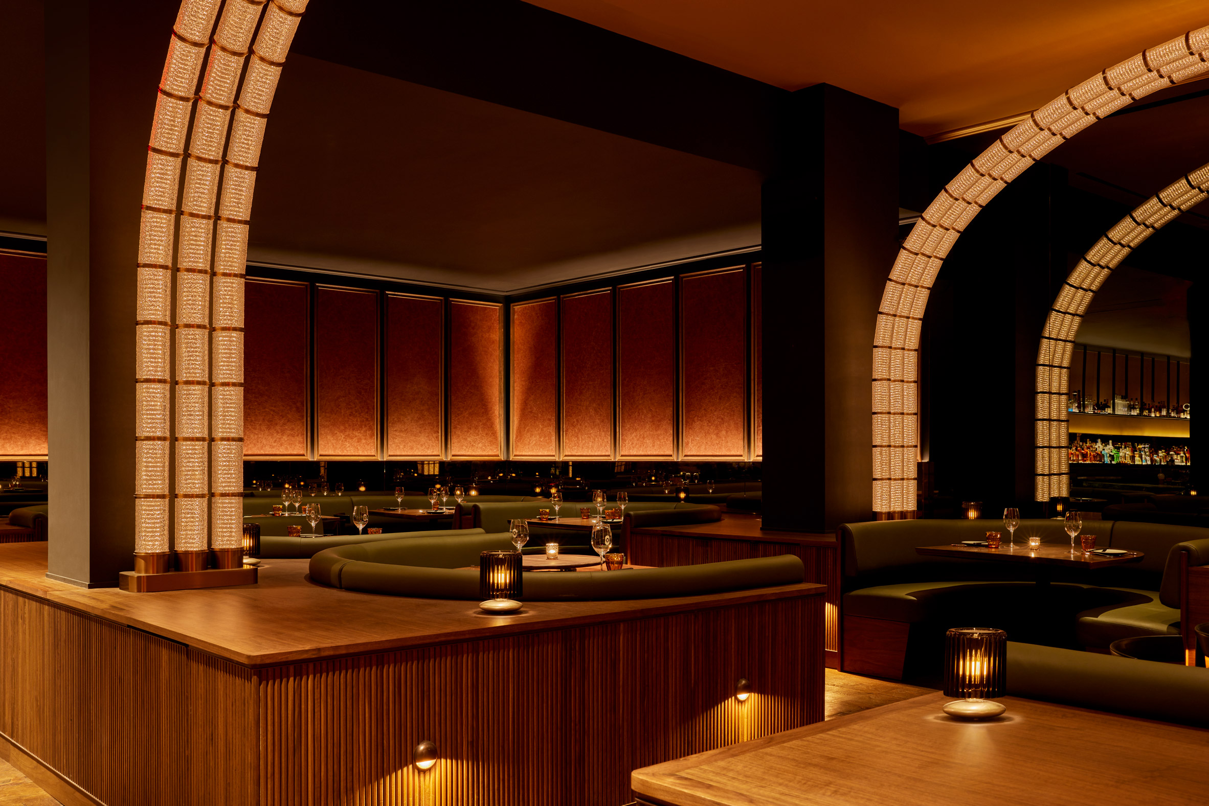Restaurant interior with moody material palette and warm lighting