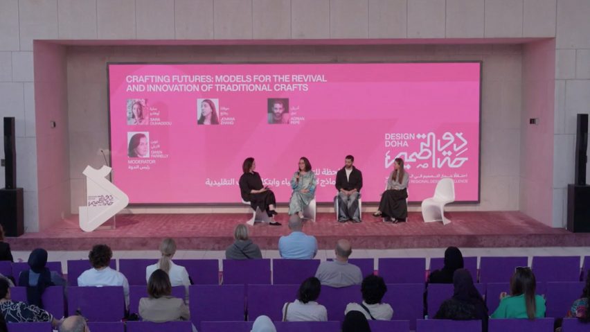 Video frame of speakers on stage at the Crafting Futures panel at Design Doha, viewed from the back of the auditorium