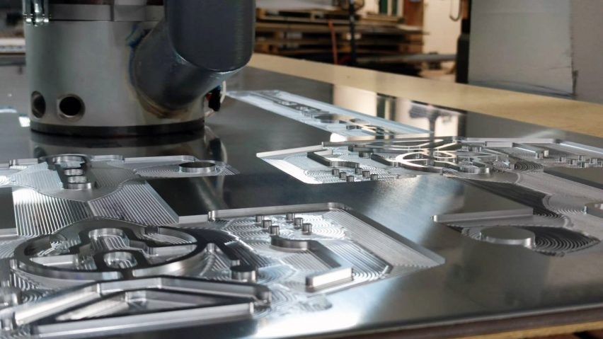 CNC milling machine cutting a piece of metal