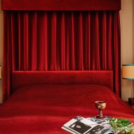 Velvet red bedspread and drapes in Locke studio-style apartment
