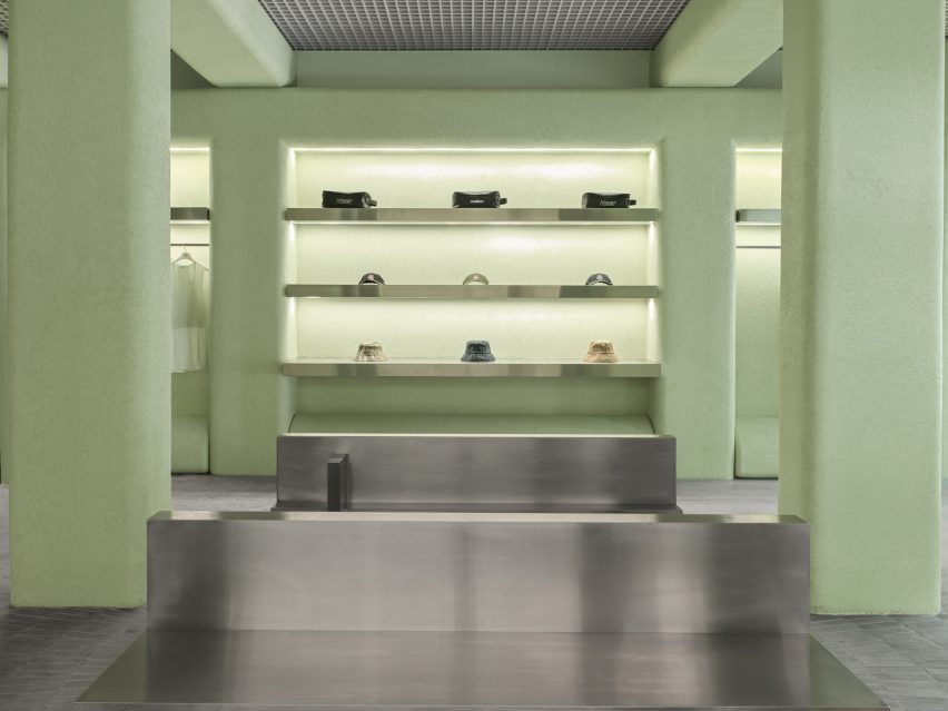Accessories displayed on stainless steel shelves, surrounded by green stucco