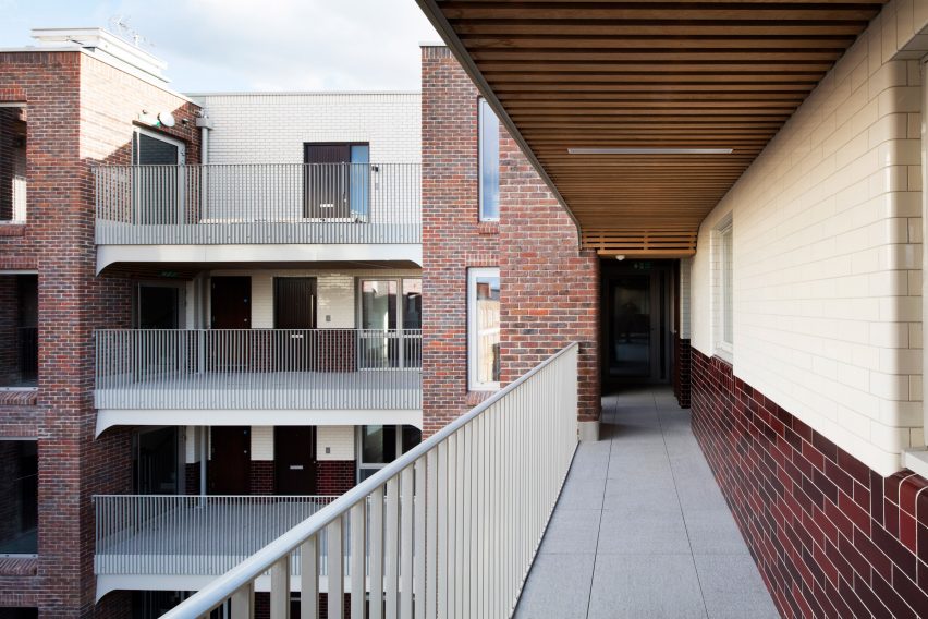 Deck access walkway at Grade II-listed estate by Matthew Lloyd Architects