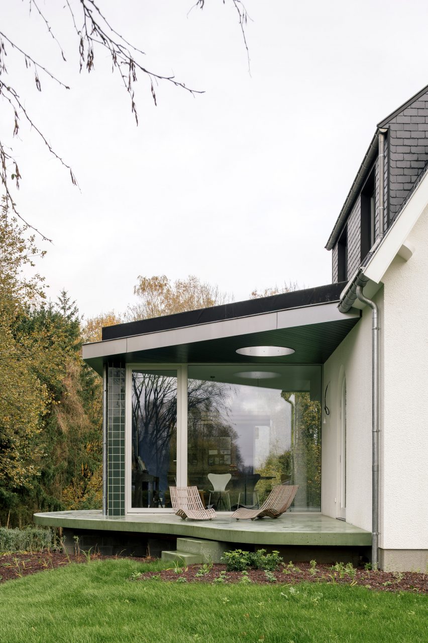 Green-tiled home extension on a concrete terrace