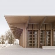 Overhanging roof shelters wooden hall in Germany by Steimle Architekten