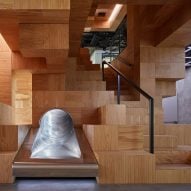 Collcoll hides stairs and seats in pixellated wooden structure at Pricefx office