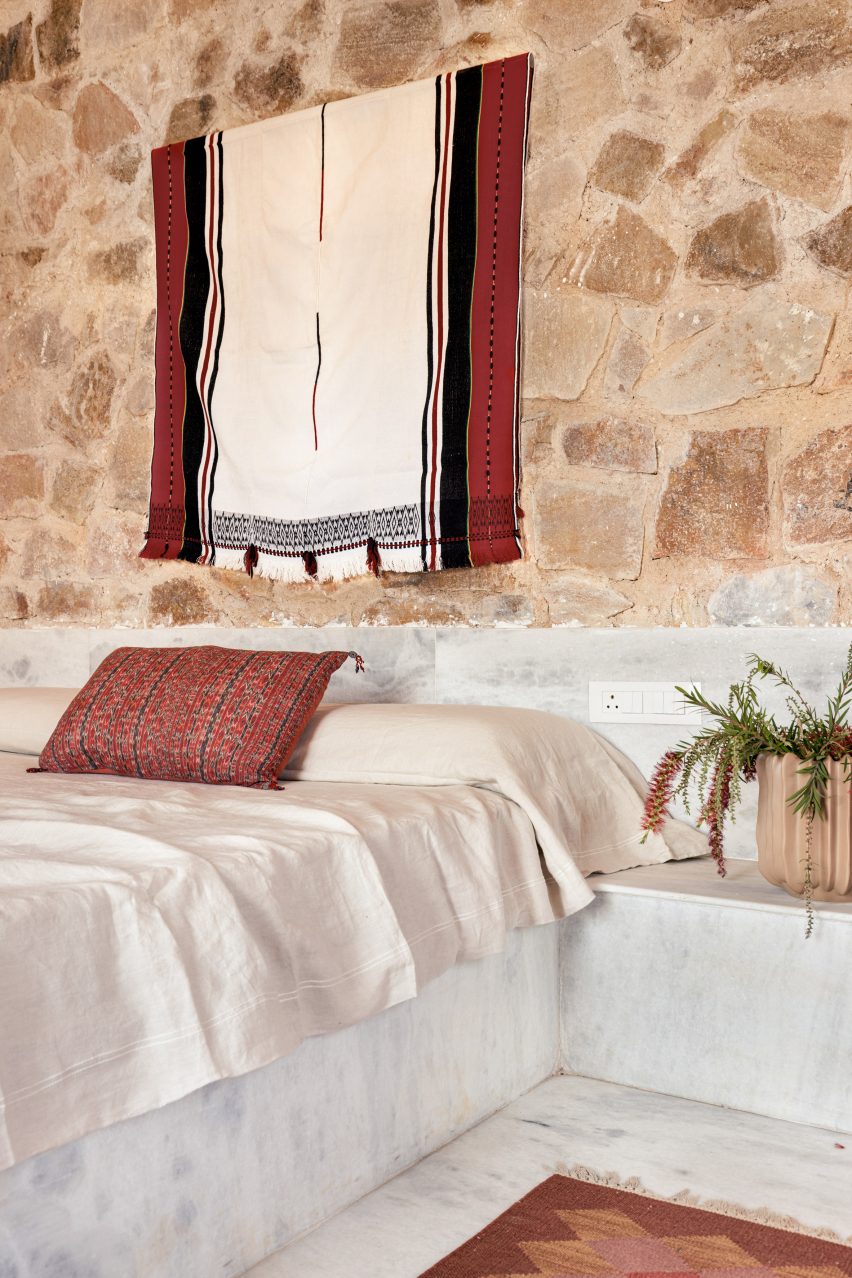 Bedroom with exposed stone wall