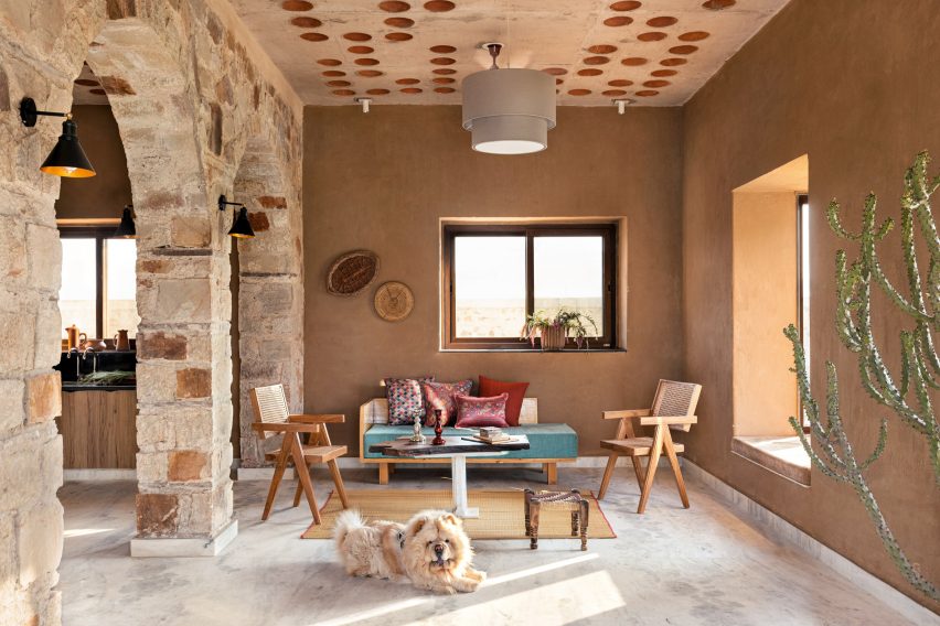 Living room of Stone House by Sketch Design Studio with dog