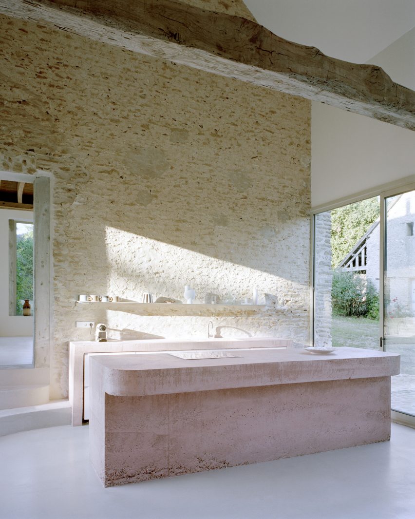 Pink concrete kitchen island in Maison Hercourt by Studio Guma in Normandy