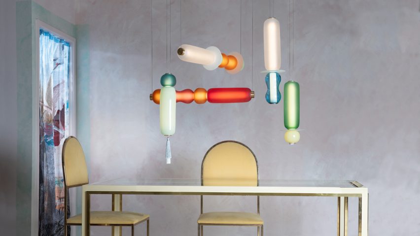 Photo of the Wave II pendant lights by Curiousa hanging above a table
