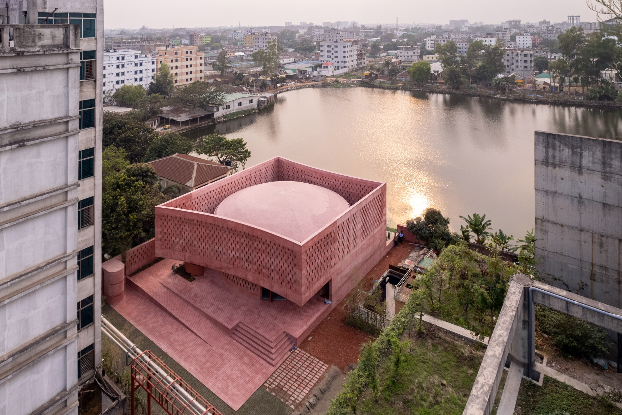 Aerial of Zebun Nessa Mosque by Studio Morphogenesis surrounded by waterbody