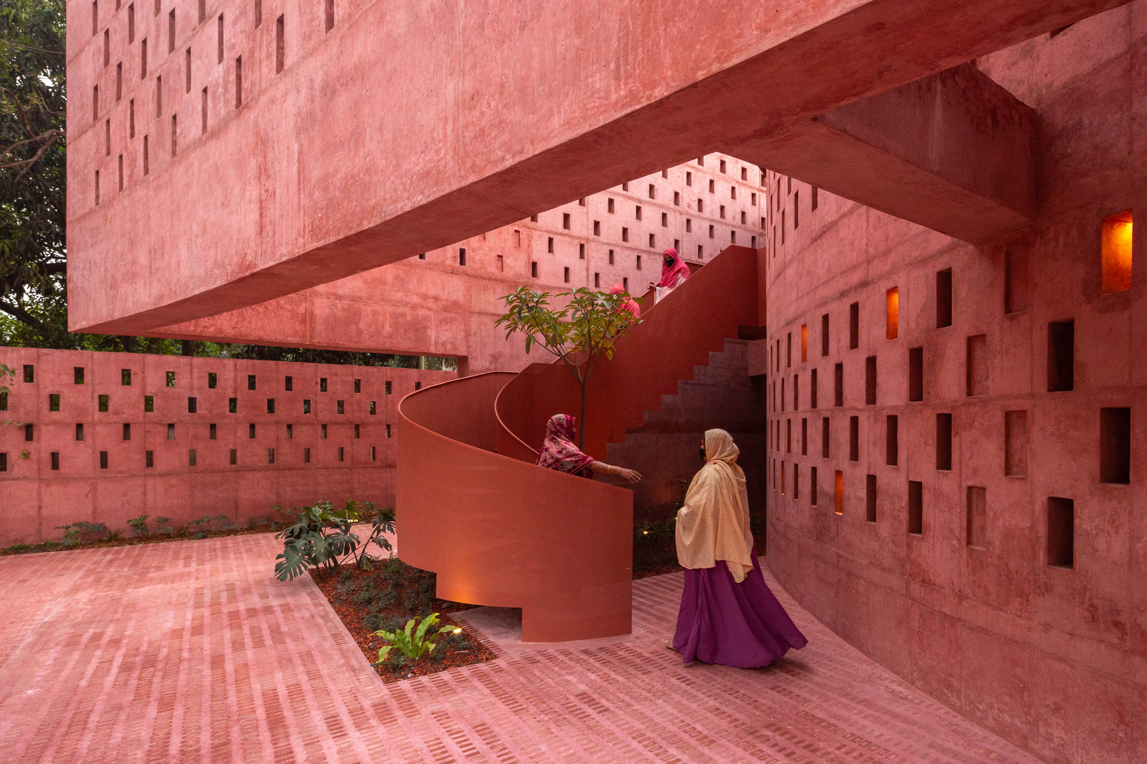 Women climbing up the spiral steel staircase of the Zebun Nessa Mosque by Studio Morphogenesis