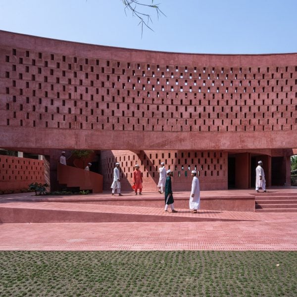 Monolithic pink concrete forms waterside mosque in Bangladesh