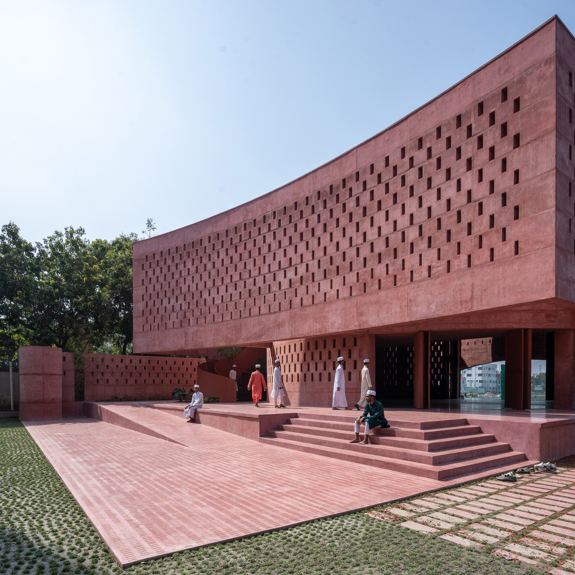 Worshippers walking into the Zebun Nessa Mosque by Studio Morphogenesis in Bangladesh