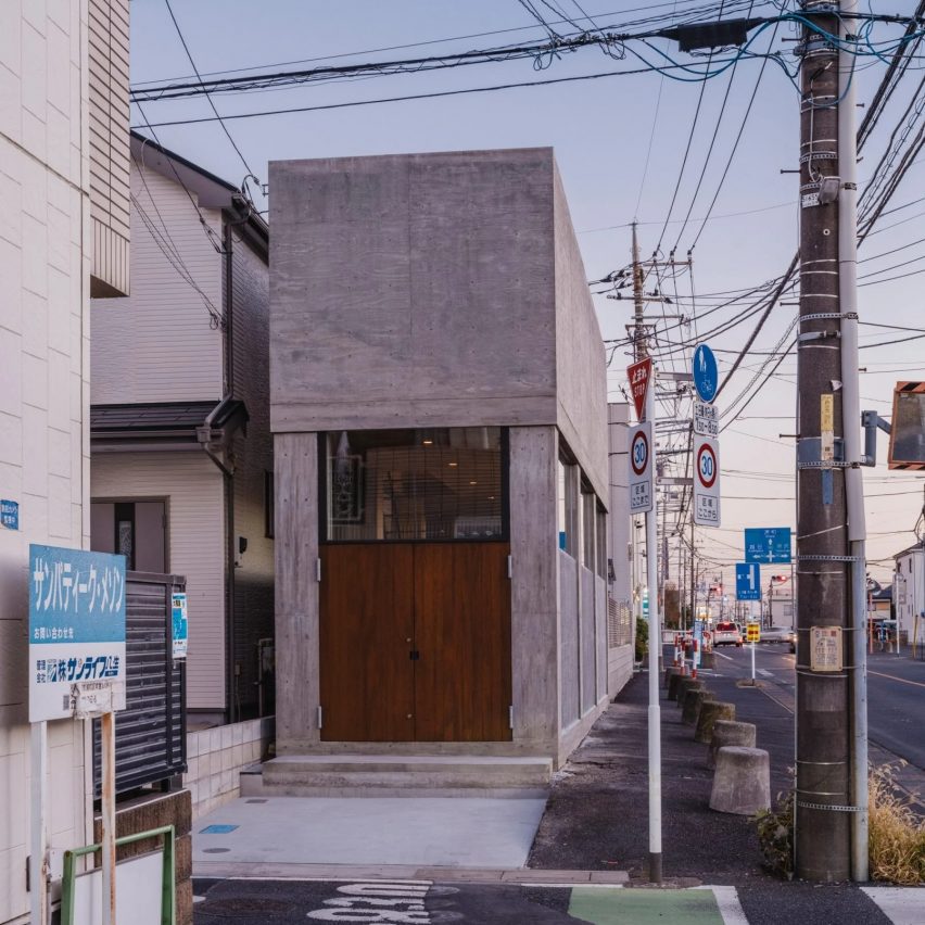 Skinny concrete house on roadside Japan