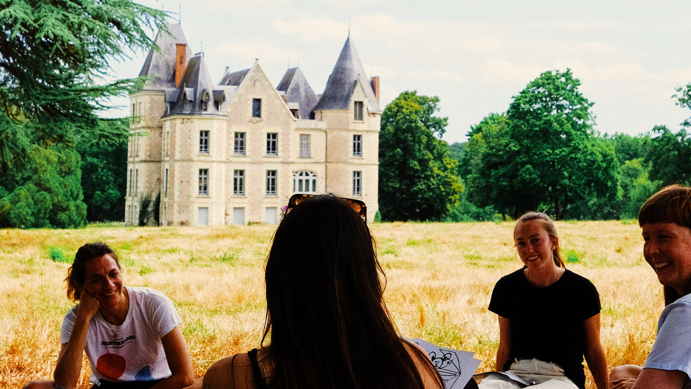 Photo if people sat near a stately home