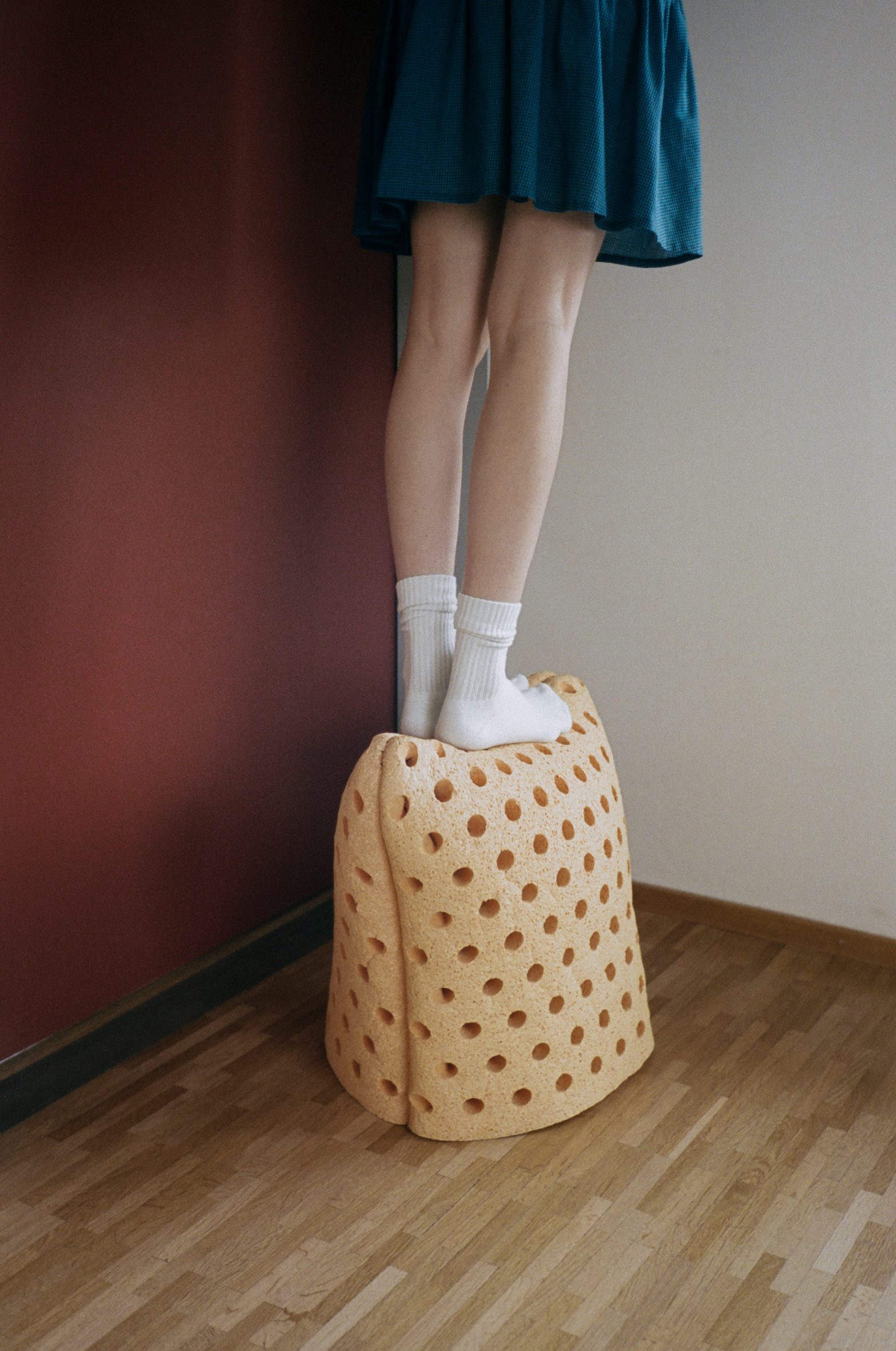 Person standing on cellulose foam stool by Chris Kabel